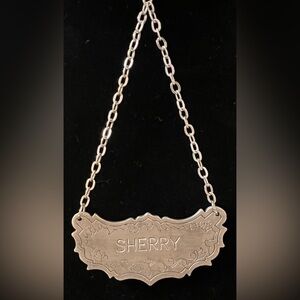 Metal Sherry bottle tag.